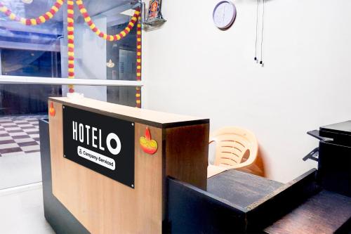 a ticket booth with a hotel sign in a room at Super Hotel O Laxmi Chowk Hinjewadi in Pune