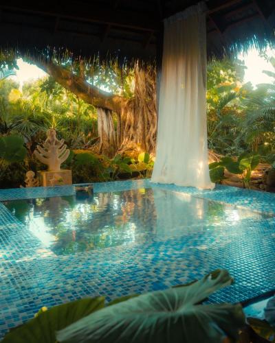 a swimming pool in the middle of a garden at Zoetry Agua Punta Cana - All Inclusive in Punta Cana