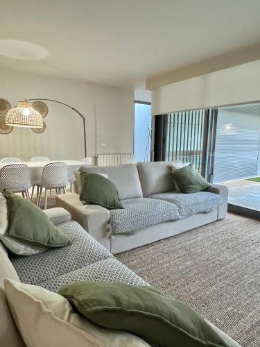 a living room with a couch and a table at Casa do Poço in Caminha