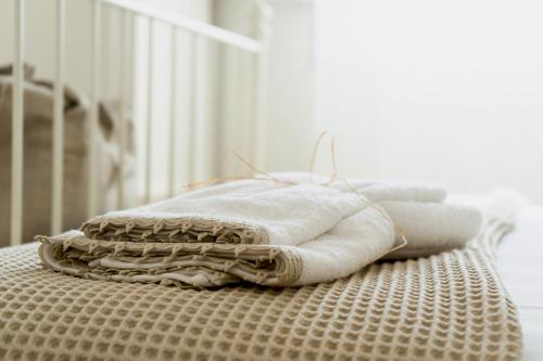 a stack of towels sitting on top of a table at "Lo Studiolo" in Nardò