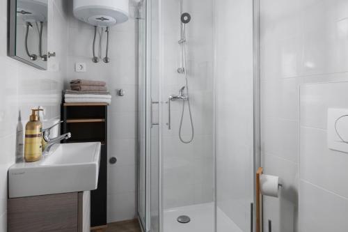 a bathroom with a sink and a shower at Apartment Miha in Loborika