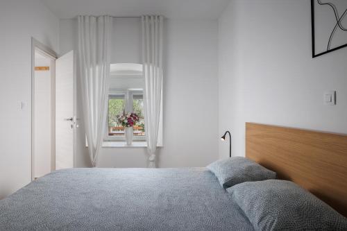 a bedroom with a large bed and a window at Apartment Miha in Loborika