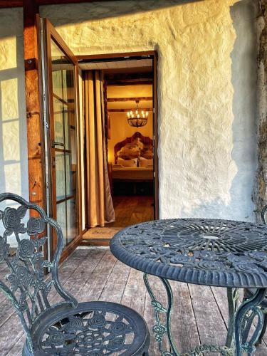 a wrought iron table and chair on a patio at Trapani house & camp in Růžová