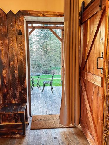 an open door to a porch with a bench outside at Trapani house & camp in Růžová