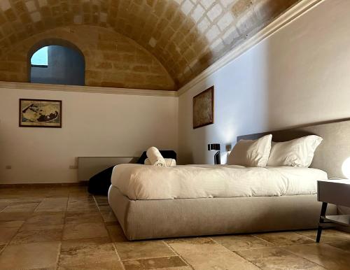 a bedroom with a large bed in a room at Residence Masseria Santa Lucia in Matera