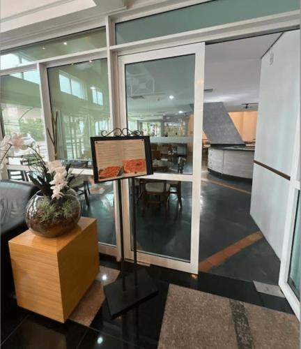 a living room with a table with a picture on it at HOTEL PERDIZES - FLAT Executivo - 1206 in Sao Paulo
