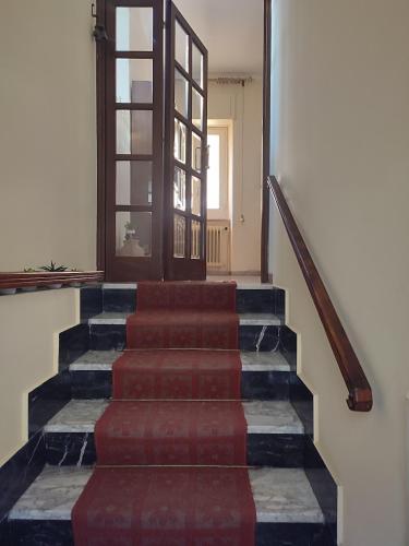 a set of stairs in a building with a door at Antica dimora Cauto in Pietramelara