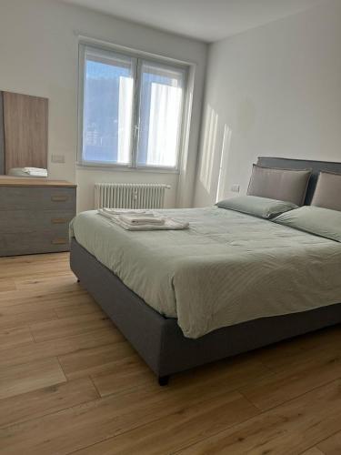 a bedroom with a large bed and a dresser at The VIEW - Spacious modern apt in Como