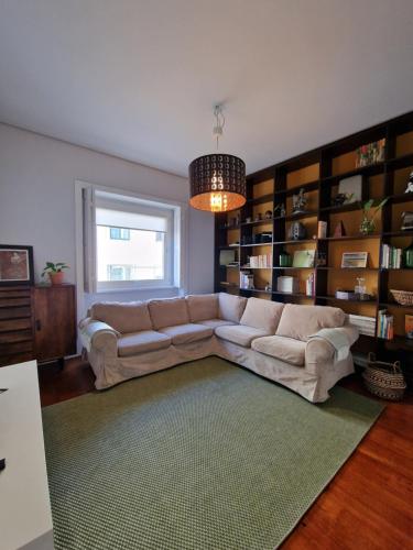 a living room with a couch and book shelves at Lima Junior Residences in Porto