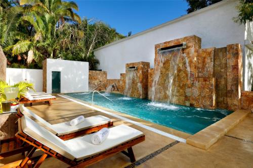 a swimming pool with a waterfall in a house at Grand Palladium Vallarta Resort & Spa - All Inclusive in Punta Mita
