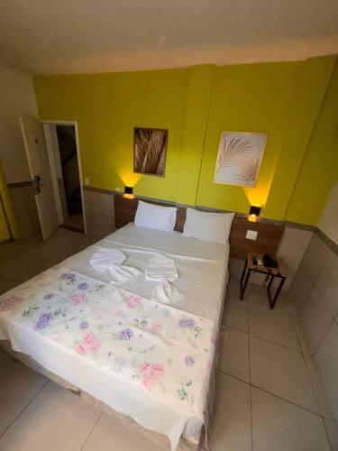 a bedroom with a bed with flowers on it at Villa Mar Boa Viagem in Recife