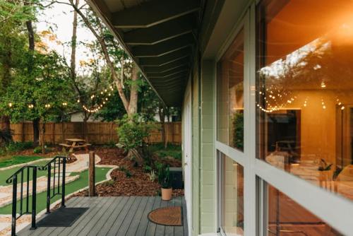 a porch with a view of a yard with lights at Boho 4BR Oasis w Mini Golf & Games in Gainesville