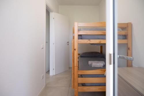 a room with a bunk bed and a ladder at La Rocca Terrazza in Darfo