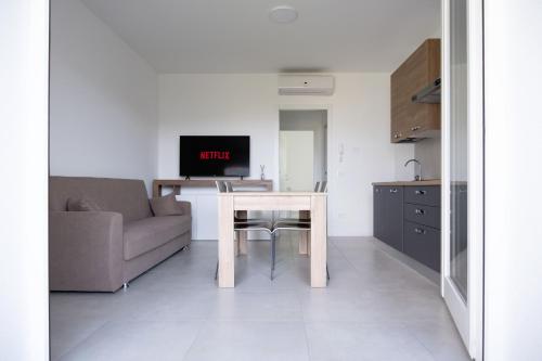 a living room with a table and a couch at La Rocca Terrazza in Darfo