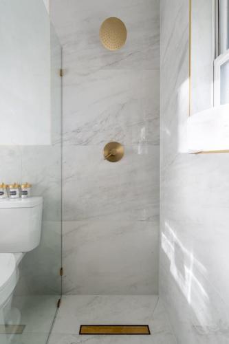 a bathroom with a glass shower with a toilet at Boho 4BR Oasis w Mini Golf & Games in Gainesville