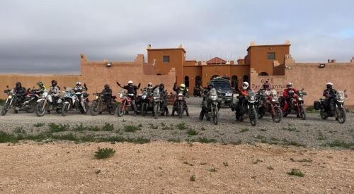 a group of people on motorcycles parked in front of a building at DAR AL QANASS IMANE in Midelt