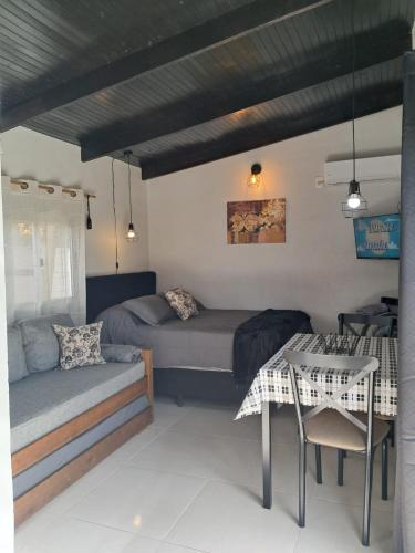 a room with a bed and a table and a couch at Descanso al Paso Chuy in Chuy