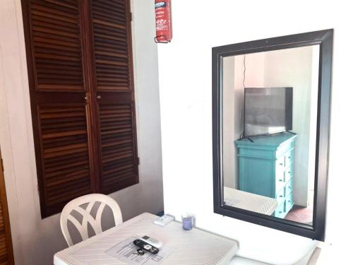 a mirror next to a table with a dresser at BLR Villas Dover Beach in Christ Church