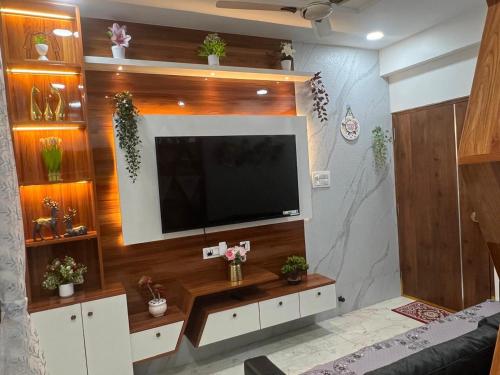 a living room with a flat screen tv on a wall at Atlas Homes 1BHK HomeStays in Hyderabad