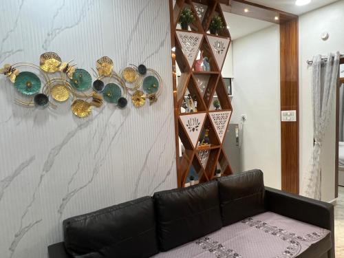 a living room with a couch and a wine rack at Atlas Homes 1BHK HomeStays in Hyderabad