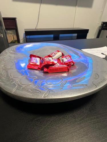 a plate with two packets of candy on a table at Artistic & cozy ! Just 5' to seaside in Athens