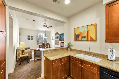 a kitchen with a sink and a living room at Ground Floor 1BR Legacy Villa #A in La Quinta