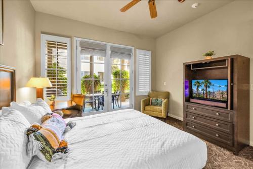 a bedroom with a large bed and a television at Ground Floor 1BR Legacy Villa #A in La Quinta