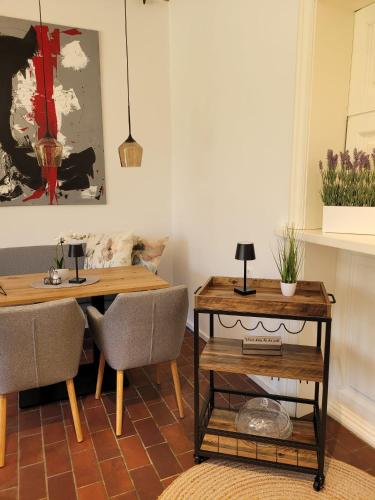 a dining room with a table and chairs and a table at Landhaus am Kurpark in Baden