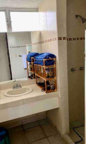 a bathroom with a sink and a mirror at NEW loft on the beach with direct access in Ixtapa