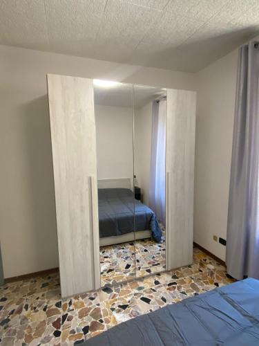a bedroom with a mirror and a bed at Casa Franca - Vacation Apartment in San Pellegrino Terme