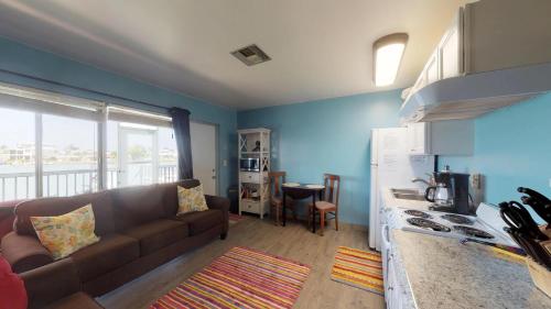 a living room with a couch and a kitchen at Driftwood Landing 11 in Naples