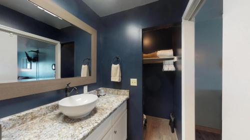 a bathroom with a white sink and a mirror at Driftwood Landing 11 in Naples