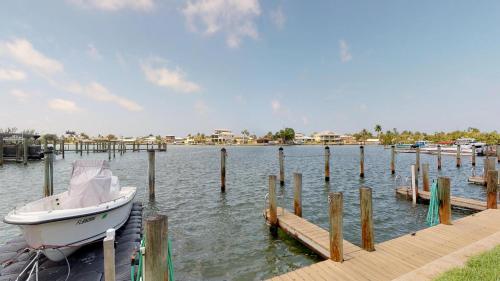 a boat is docked at a dock in the water at Driftwood Landing 11 in Naples