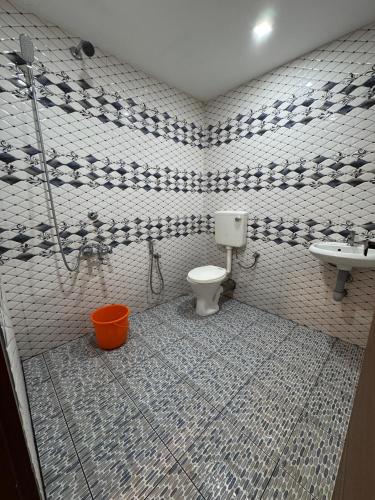 a bathroom with a toilet and a sink at Heres Haut Residency in Ernakulam