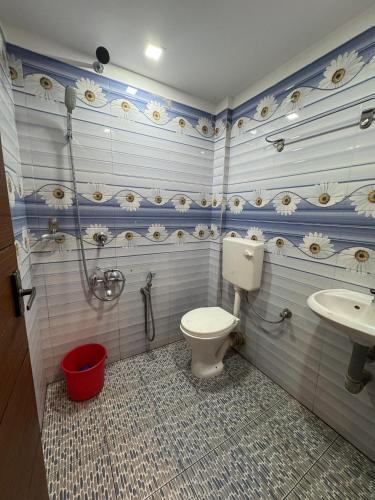 a bathroom with a toilet and a sink at Heres Haut Residency in Ernakulam