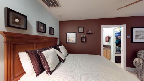 a bedroom with a bed with pillows on it at Driftwood Landing 14 in Naples