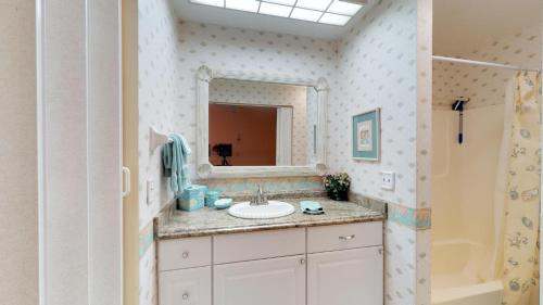a bathroom with a sink and a mirror at Driftwood Landing 10 in Naples