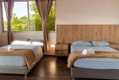 Ένα ή περισσότερα κρεβάτια σε δωμάτιο στο Hotel Campestre Alto lindo en Guatapé