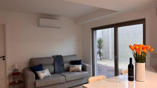 a living room with a couch and a table at Apartment at the Beach in Aveiro