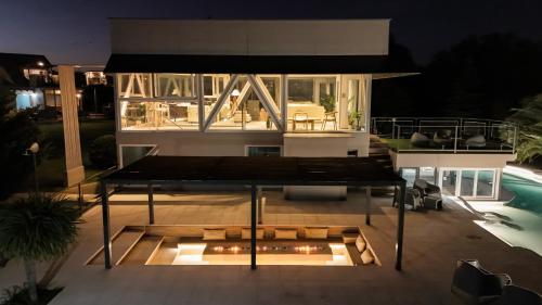a house with a bench on a patio at night at Cabañas Rio Soñado in Valle Grande