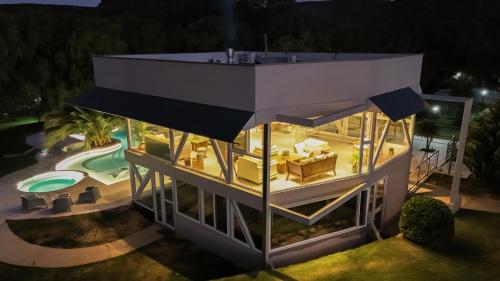 an overhead view of a house with a pool at night at Cabañas Rio Soñado in Valle Grande