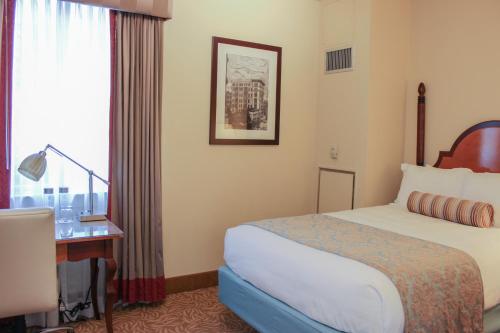 a hotel room with a bed and a window at Hotel Providence in Providence