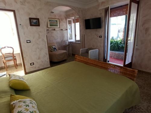 a bedroom with a large green bed in a room at Villa dei fiori B&B in Capri