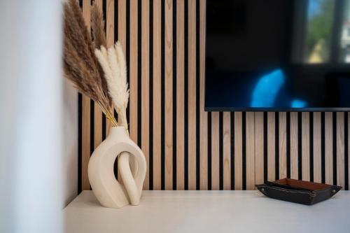 a vase with feathers in it sitting on a table at Da Vinci B&B in Florence