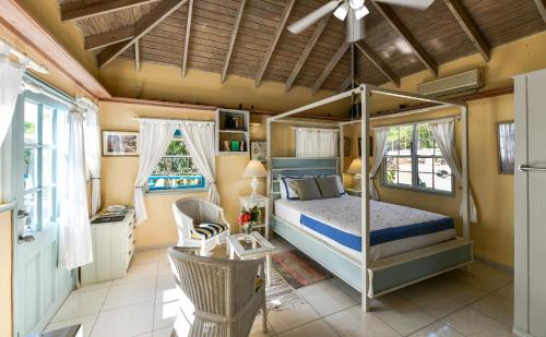 a bedroom with a canopy bed in a room at Titi Vacation Homes in Cobbs Cross