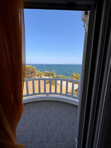 a view of the ocean from a balcony at Soros Seaside Villa in Kritharia