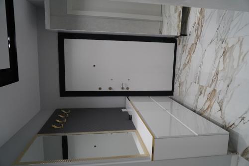 a walk in closet with a white wall at Luxury holidays shengjin in Shëngjin