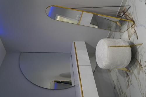 a bathroom with a toilet with a mirror and a roll at Luxury holidays shengjin in Shëngjin