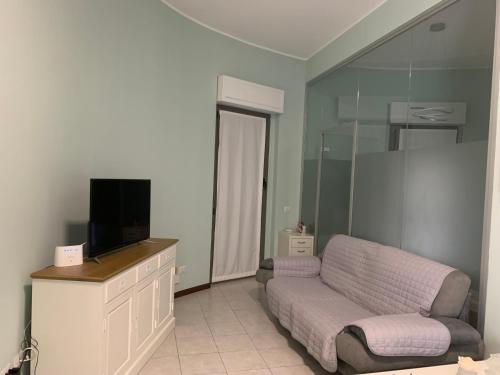 a living room with a couch and a flat screen tv at Seregno Dolce Vita in Seregno
