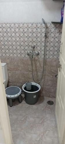 a bathroom with a shower and a toilet at Atlas Homes 1BHK HomeStays in Hyderabad